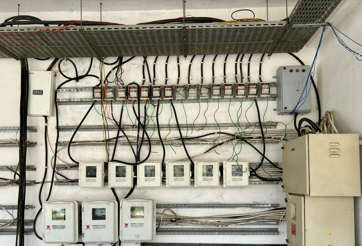An open electrical panel showing breakers and available spaces