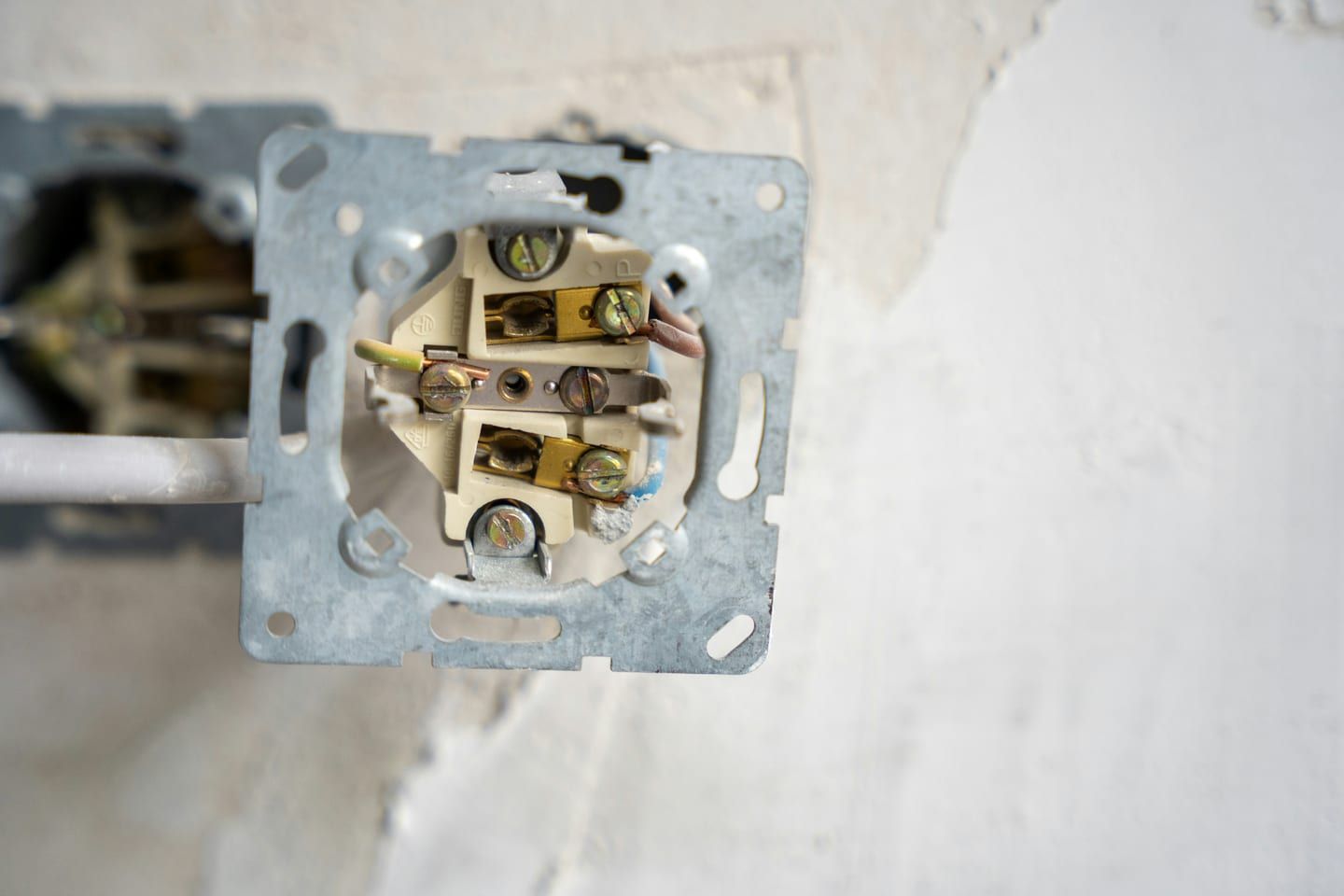 A hardwired EV charger beside a NEMA 14-50 outlet install